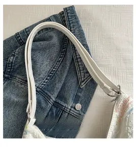 Detail of white tote bag featuring colorful wave embroidery and leather strap