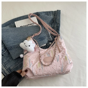 Pink quilted shoulder bag with colorful embroidery, leather strap, and cloud pendant