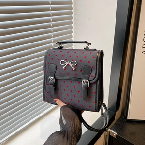 Chic grey backpack for women featuring red heart patterns and silver bow buckle