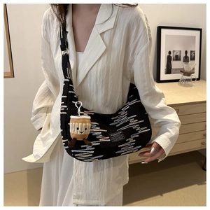 Fashionable black crescent canvas bag with wave embroidery and cute coffee plush charm