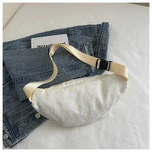 Detail of white woven texture waist bag on denim jacket with adjustable buckle strap