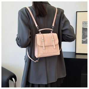 Pink pleated texture backpack with adjustable straps and silver rings on model