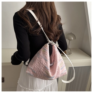 Pink pleated nylon crossbody bag with embroidery and white leather strap on model