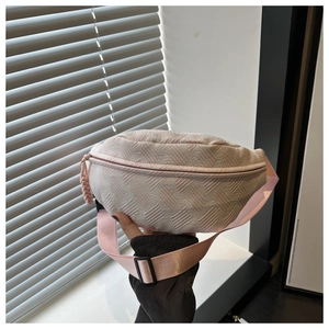 Detail of light pink textured crescent bag with jacquard fabric and adjustable strap