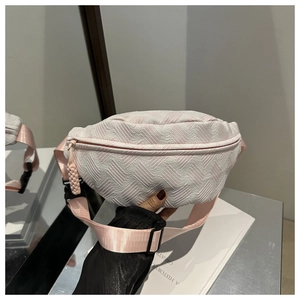 Detail of pink and white textured cross body bag with adjustable strap and buckle