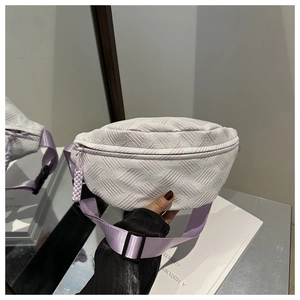 Detail of lavender purple crossbody bag with geometric woven texture and adjustable strap