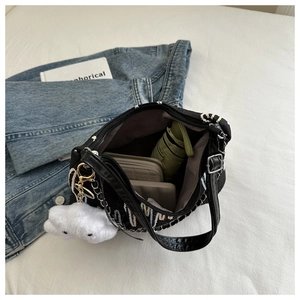 Interior view of black canvas tote showing large capacity for phone, wallet and umbrella