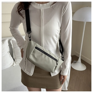 Minimalist light grey green nylon crossbody bag with wide adjustable shoulder strap