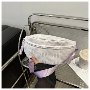 Detail of light purple woven chest bag texture with adjustable nylon strap and zipper