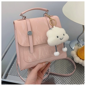 Pink glossy faux leather handbag with cute white cloud charm and detachable shoulder strap