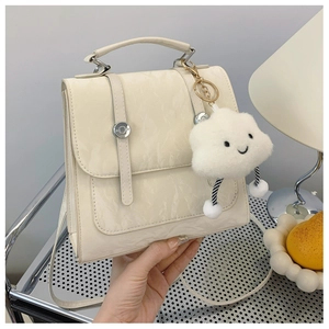 Detail of off-white marble texture backpack with silver buckle and cloud charm