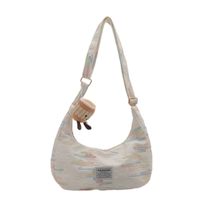 White nylon half-moon crossbody bag with colorful wavy embroidery and plush charm