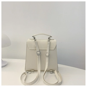 Rear view of white PU leather backpack showing adjustable straps and metal hooks