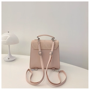 Close-up of pink mini backpack back view with adjustable straps and silver hardware