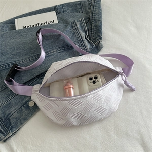 White textured sports fanny pack with purple strap showing large internal capacity