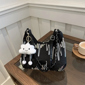 Minimalist black canvas hobo bag with colorful wave embroidery and cloud charm