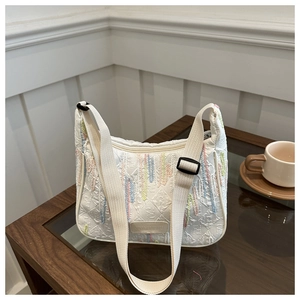 Detail of white canvas Hobo bag with colorful vertical stripes and textured fabric