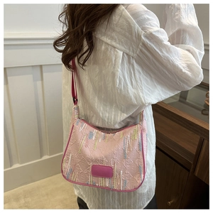 Detailed view of pink nylon shoulder bag with colorful embroidery and FF pattern