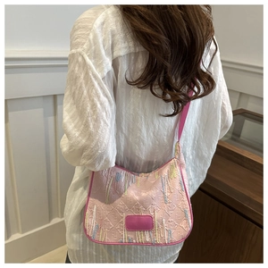 Detail of pink shoulder bag with colorful wave embroidery and luxury logo pattern