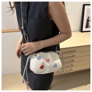 White cloud-shaped crossbody bag with colorful heart patches and silver chain strap
