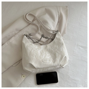 Detail of white wrinkled texture bag with chain strap and 'FASHION & BAG' label