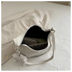 Top view of cream hobo bag interior showing space for phone, wallet and folded umbrella