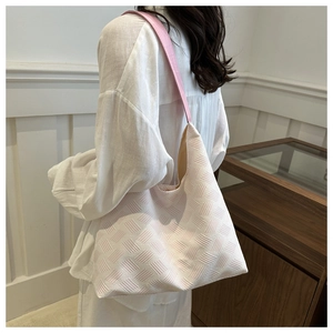Close-up of pink and white woven texture on stylish shoulder bag for spring and summer
