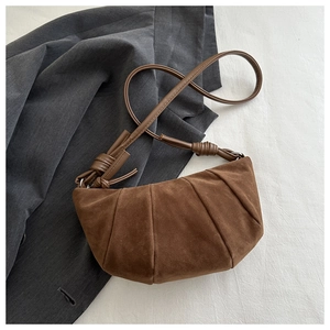 Brown suede crescent bag with pleated texture and leather knotted strap detail