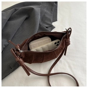 Interior view of brown faux suede shoulder bag showing storage for phone and wallet