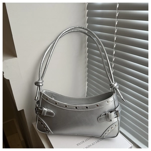 Detail of silver metallic baguette bag with rivet studs and adjustable buckle side straps