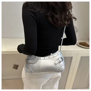 Rear view of silver studded baguette bag on model showing size and metallic texture