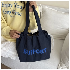 Détail du cabas à cordon bleu marine avec imprimé SUPPORT sur tissu imperméable