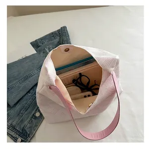 Pink textured bubble tote bag with spacious interior shown from a high-angle lifestyle view