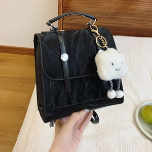 Versatile black pleated backpack for women with plush cloud charm and silver hardware