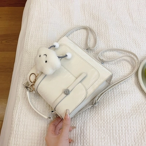 Versatile cream faux leather backpack for women with shiny finish and cute cloud charm