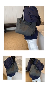 Detail view of a grey tote bag with black star prints and a silver bow on the shoulder