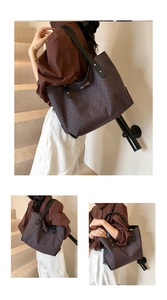 Detailed view of large tote bag with red heart pattern and metallic bow accent