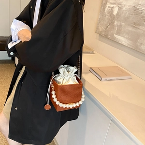 Brown textured leather box bag with pearl handle and drawstring interior for women