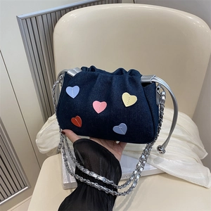 Blue denim bucket bag with colorful heart patches and silver chain strap for women