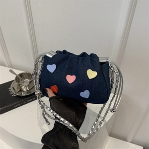 Denim drawstring bucket bag with colorful heart patches and silver chain strap