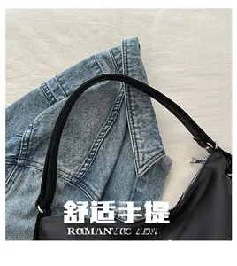 Detail of soft nylon shoulder bag handles with silver metal zippers and minimalist design