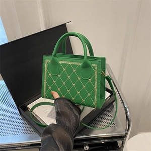Green PU leather square crossbody bag with heart quilting and gold hardware handles