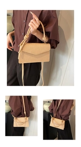 Detail of beige pleated handbag with knotted handle and slim shoulder strap on model