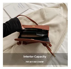 Interior view of brown corduroy crossbody bag showing capacity for phone and cosmetics