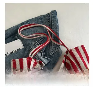 Close-up of red and white striped canvas tote bag with reinforced fabric handles