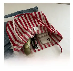 Spacious red and white striped canvas tote bag showing interior with magnetic silver clasp