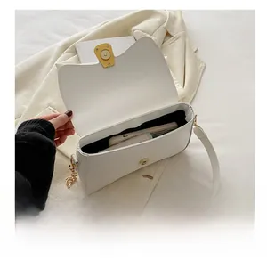 Interior capacity of the white leather crossbody bag showing space for a smartphone