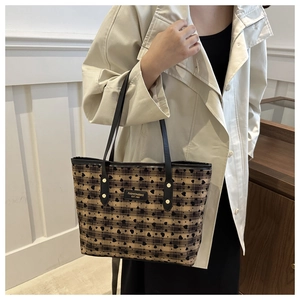 Detail of vintage tote bag with heart pattern and Fashion&Bag Est.1985 leather patch