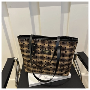 Close-up of heart checkered tote bag on a chair with vintage urban style details
