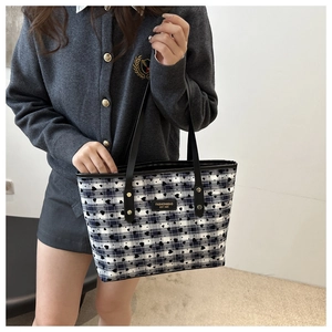 Close-up of heart pattern tote bag with blue checkered fabric and leather label